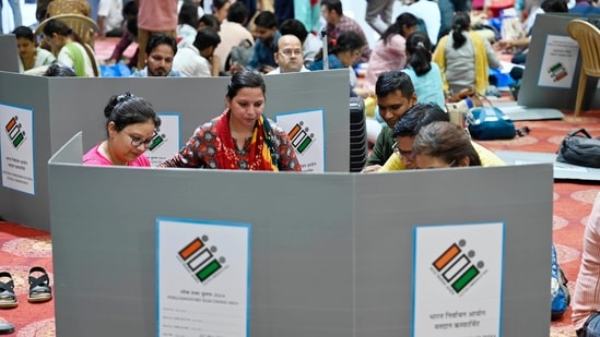 New Delhi, India - May 24, 2024: Polling officials with EVM machines as they collect and sort polling material ahead of the 2024 Loksabha elections to be held tomorrow, at Akshardham Commonwealth Sports Complex in New Delhi, India, on Friday, May 24, 2024. (Photo by Raj K Raj/ Hindustan Times) New Delhi, India - May 24, 2024: Polling officials with EVM machines as they collect and sort polling material ahead of the 2024 Loksabha elections to be held tomorrow, at Akshardham Commonwealth Sports Complex in New Delhi, India, on Friday, May 24, 2024. (Photo by Raj K Raj/ Hindustan Times)