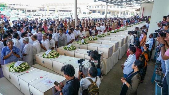 Relatives mourn near the deceased after the coffins' arrival on an Indian Air Force plane from Kuwait at the Cochin International Airport in Kochi on June 14. (AFP)