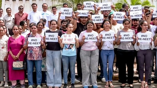 Students hold placards as they stage a protest against the re-examination of the NEET-UG exams, in Rajkot on Sunday. (ANI Photo)