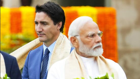 FILE - Canada's Prime Minister Justin Trudeau, left, walks past India's Prime Minister Narendra Modi as they take part in a wreath-laying ceremony at Raj Ghat, Mahatma Gandhi's cremation site, during the G20 Summit in New Delhi, File) (AP FILE)