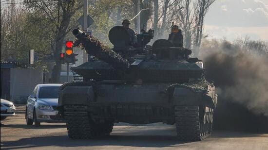 Russian army servicemen drive a tank on a street in Donetsk, Russian-controlled Ukraine (REUTERS FILE)