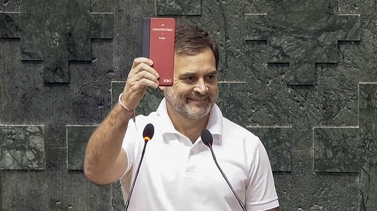 Congress MP Rahul Gandhi shows a copy of the Constitution of India while taking oath as a Member of the 18th Lok Sabha during its second day, at the Parliament, in New Delhi on Monday.(ANI )