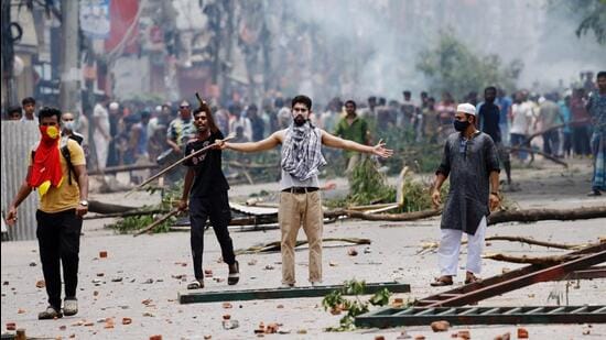 A demonstrator gestures as protesters clash with Border Guard Bangladesh (BGB) and the police outside the state-owned Bangladesh Television as violence erupts across the country after anti-quota protests by students in Dhaka (REUTERS) A demonstrator gestures as protesters clash with Border Guard Bangladesh (BGB) and the police outside the state-owned Bangladesh Television as violence erupts across the country after anti-quota protests by students in Dhaka (REUTERS)