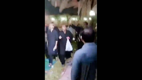 This image grab from a UGC video taken on July 16, 2024 shows shows people fleeing the scene of a shooting at the Imam Ali Mosque in the Al-Wadi Al-Kabir area in the east of Oman's capital Muscat. (Photo by UGC / AFP) / RESTRICTED TO EDITORIAL USE � MANDATORY CREDIT � AFP PHOTO / [SOURCE] � - NO MARKETING NO ADVERTISING CAMPAIGNS � DISTRIBUTED AS A SERVICE TO CLIENTS [- NO ARCHIVE ]