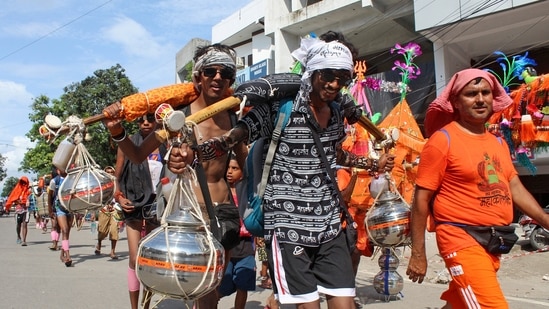 Kanwariyas (Shiva devotees) carry pots filled with water collected from Gangariver during the annual 'Kanwar Yatra', in Haridwar on Thursday. (ANI Photo) (Princess Ilvita)