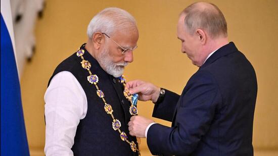 Russian President Vladimir Putin awards Prime Minister Narendra Modi with the Order of St. Andrew the Apostle the First-Called during a ceremony following their talks at the Kremlin in Moscow on July 9 (AFP)