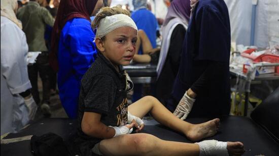 A wounded Palestinian child being treated after the Israeli bombardment of the United Nations Relief and Works Agency for Palestine Refugees run school, turned shelter, where internally displaced Palestinians are living (AFP)