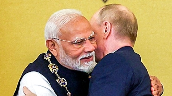 Prime Minister Narendra Modi embraces Russian President Vladimir Putin after receiving the Order of St Andrew the Apostle the First-Called, Russia's highest civilian honour, at St Catherine's Hall, in Moscow. (ANI Photo)(ANI)