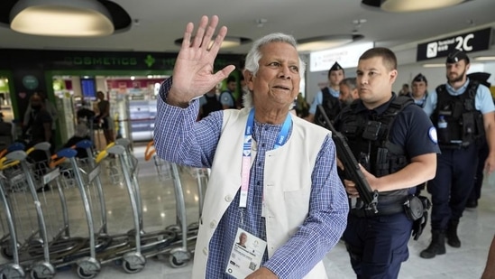 Nobel laureate Muhammad Yunus waves to the media at Charles de Gaulle's airport in Roissy, north of Paris, Wednesday. (AP) Nobel laureate Muhammad Yunus waves to the media at Charles de Gaulle's airport in Roissy, north of Paris, Wednesday. (AP)