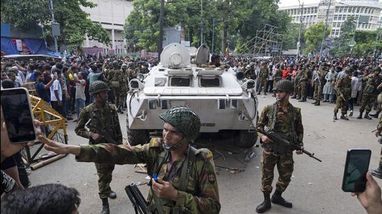 Bangladeshi security officers keep vigil on a street in Dhaka on Monday. (AP) Bangladeshi security officers keep vigil on a street in Dhaka on Monday. (AP)