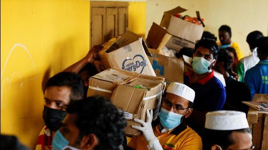 Volunteers carry boxes of rations to a relief camp, after landslides hit several villages in Wayanad district, in Meppadi, in the southern state of Kerala (REUTERS)