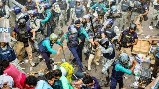 Police personnel baton-charge protesting supporters of Chinmoy Krishna Das, a jailed Hindu monk leader and spokesperson of the Bangladesh Sammilito Sanatan Jagaran Jote group (AFP)