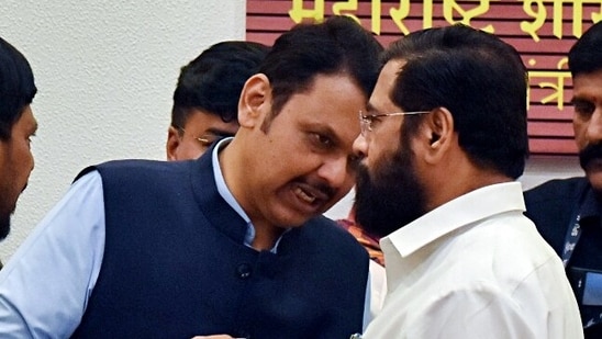 Maharashtra Chief Minister Eknath Shinde in a conversation with Deputy CMs Devendra Fadnavis during a press conference as the Mahayuti is set to form the government in the state, at Varsha Bungalow in Mumbai on Saturday. (ANI Photo) (Deepak Salvi)