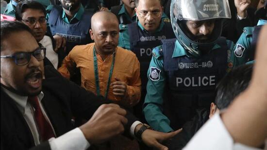 Chinmoy Krishna Das, a Hindu leader and spokesperson of being escorted by the police at the Chattogram metropolitan magistrate court in Chattogram, Bangladesh. (REUTERS)