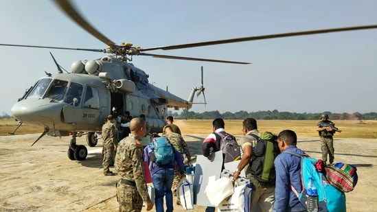 Polling officials with EVMs and other election materials board a helicopter to reach the LWE-affected areas for the first phase of Jharkhand Assembly election at Chaibasa. (PTI)(PTI)