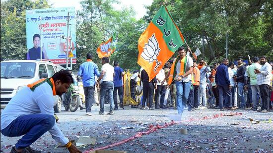 Bharatiya Janata Party (BJP) supporters burst crackers during a celebration as Maharashtra deputy chief minister and party candidate Devendra Fadnavis leads from the Nagpur South West Constituency in the state assembly elections, in Nagpur on Saturday. (ANI)