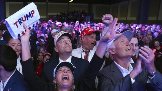 Supporters watch returns at a campaign election night watch party for Republican presidential nominee former President Donald Trump at the Palm Beach Convention Centre. (AP) Supporters watch returns at a campaign election night watch party for Republican presidential nominee former President Donald Trump at the Palm Beach Convention Centre. (AP)