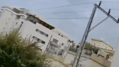 A Hezbollah rocket strikes a building. (Video credit: X/TheCradleMedia) Watch: Hezbollah fires 250 projectiles after Israeli strike on Beirut