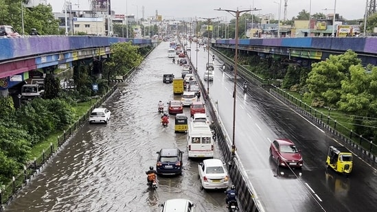 Chennai, Nov 30 (ANI): Vehicles ply on a waterlogged road following heavy rainfall triggered by Cyclone Fengal, in Chennai on Saturday.(ANI)