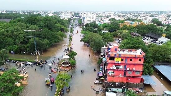 Vehicles and people wade through a flooded road amid heavy rainfall triggered by Cyclone Fengal, in Puducherry on Sunday. (ANI) Vehicles and people wade through a flooded road amid heavy rainfall triggered by Cyclone Fengal, in Puducherry on Sunday. (ANI)