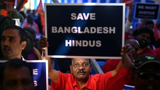 A member of the Hindu Hitarakshana Vedike holds a placard during a protest at Freedom Park in Bengaluru on December 4 against the violence on Hindu minority community in Bangladesh. (AFP)(AFP) A member of the Hindu Hitarakshana Vedike holds a placard during a protest at Freedom Park in Bengaluru on December 4 against the violence on Hindu minority community in Bangladesh. (AFP)(AFP)