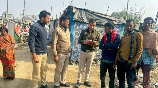 Delhi Police officials check documents of people during a verification drive to identify illegal Bangladeshi immigrants (PTI)