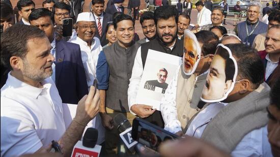 New Delhi: Leader of Opposition Rahul Gandhi interviews Congress MPs Manickam Tagore and Saptagiri Sankar Ulaka, wearing face masks of Prime Minister Narendra Modi and Adani Group chairman Gautam Adani, at a protest during the Winter session of Parliament on Monday. (PTI)