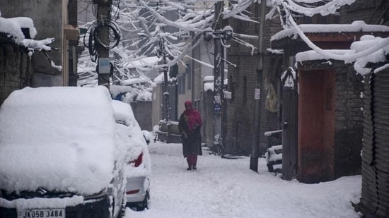 Latest news on December 30, 2024: A woman walking on a snow-covered street in Srinagar on Saturday. Heavy snowfall blocked the Srinagar-Jammu national highway and roads in several districts. (PTI Photo) Latest news on December 30, 2024: A woman walking on a snow-covered street in Srinagar on Saturday. Heavy snowfall blocked the Srinagar-Jammu national highway and roads in several districts. (PTI Photo)