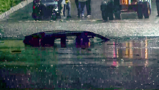 A vehicle is seen submerged at Minto Road in Delhi on Sunday after heavy rainfall.(ANI - X) A vehicle is seen submerged at Minto Road in Delhi on Sunday after heavy rainfall.(ANI - X)