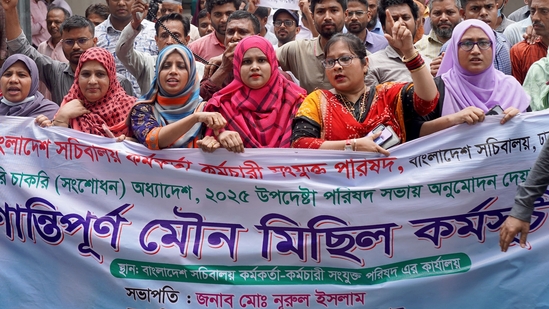 Civil officials protest inside the Secretariat building in Dhaka on May 25, 2025, demanding the repeal of a government order giving it greater power to sack employees for disciplinary breaches. Splits between Bangladesh's national tax authority and the interim government over new rules escalated May 25, extending a two week long strike that has reportedly resulted in millions of dollars of taxes go uncollected. (Photo by AFP)(AFP)