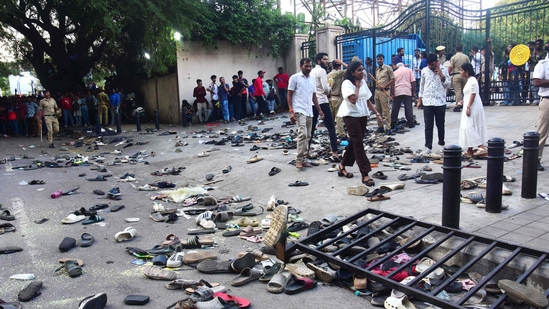 Fans stand next to abandonned shoes and a fallen barrier following a stampede during celebrations, a day after Royal Challengers Bengaluru's victory at the Indian Premier League (IPL), outside the M. Chinnaswamy Stadium in Bengaluru on June 4, 2025. (AFP) Fans stand next to abandonned shoes and a fallen barrier following a stampede during celebrations, a day after Royal Challengers Bengaluru's victory at the Indian Premier League (IPL), outside the M. Chinnaswamy Stadium in Bengaluru on June 4, 2025. (AFP)